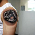 A rope knot tattoo on a man’s upper arm