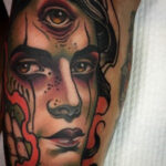 Woman applying lotion to her new arm tattoo