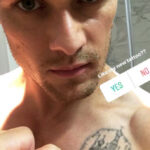 Sam Heughan's possible tattoo reveal on his left shoulder featuring a building and script, generating fan speculation and curiosity