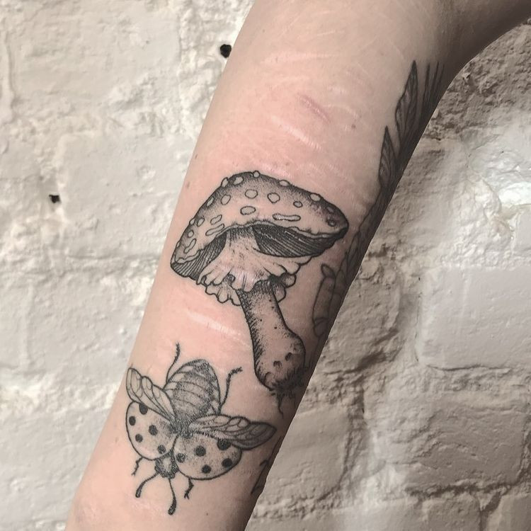 Floral tattoo covering scar on arm