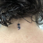 Semicolon tattoo on wrist symbolizing mental health awareness