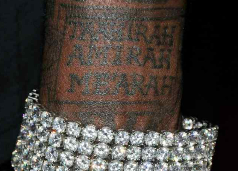 Shaquille O'Neal's tattoo dedicated to his daughters, symbolizing his love and commitment to family