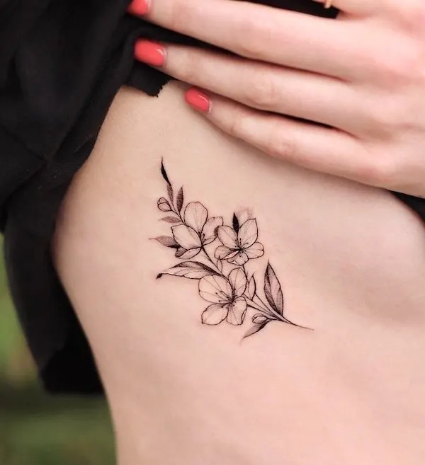Simple black and grey flower tattoo capturing classic beauty.