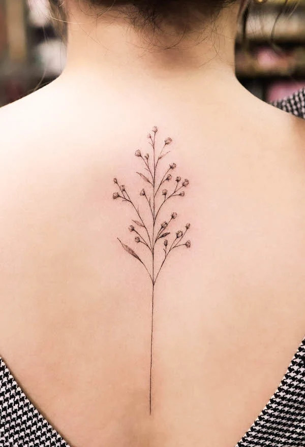 Delicate spine tattoo with small flower and leaves, designed by @tattooist_gaon