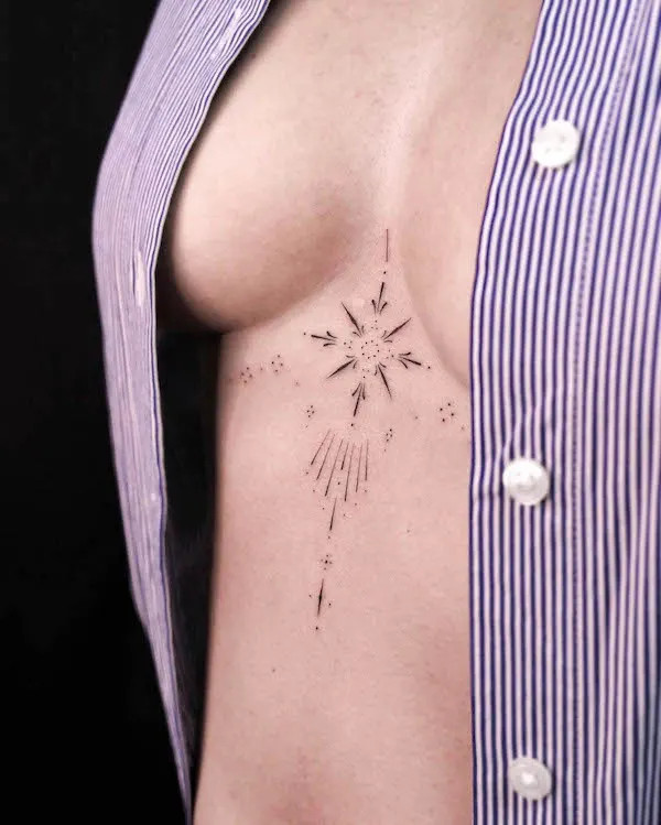 Small arrow underboob tattoo pointing towards direction and focus.