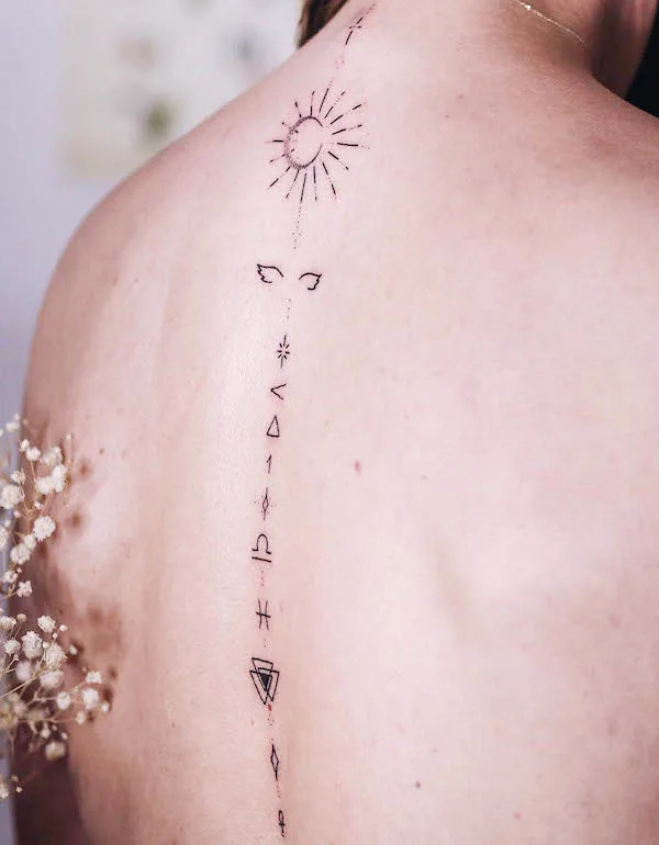Minimalist spine tattoo with small symbols aligned along the spine, designed by @miss_raven