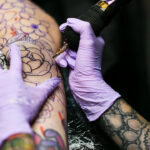 Close-up of a woman's arm with colorful tattoos