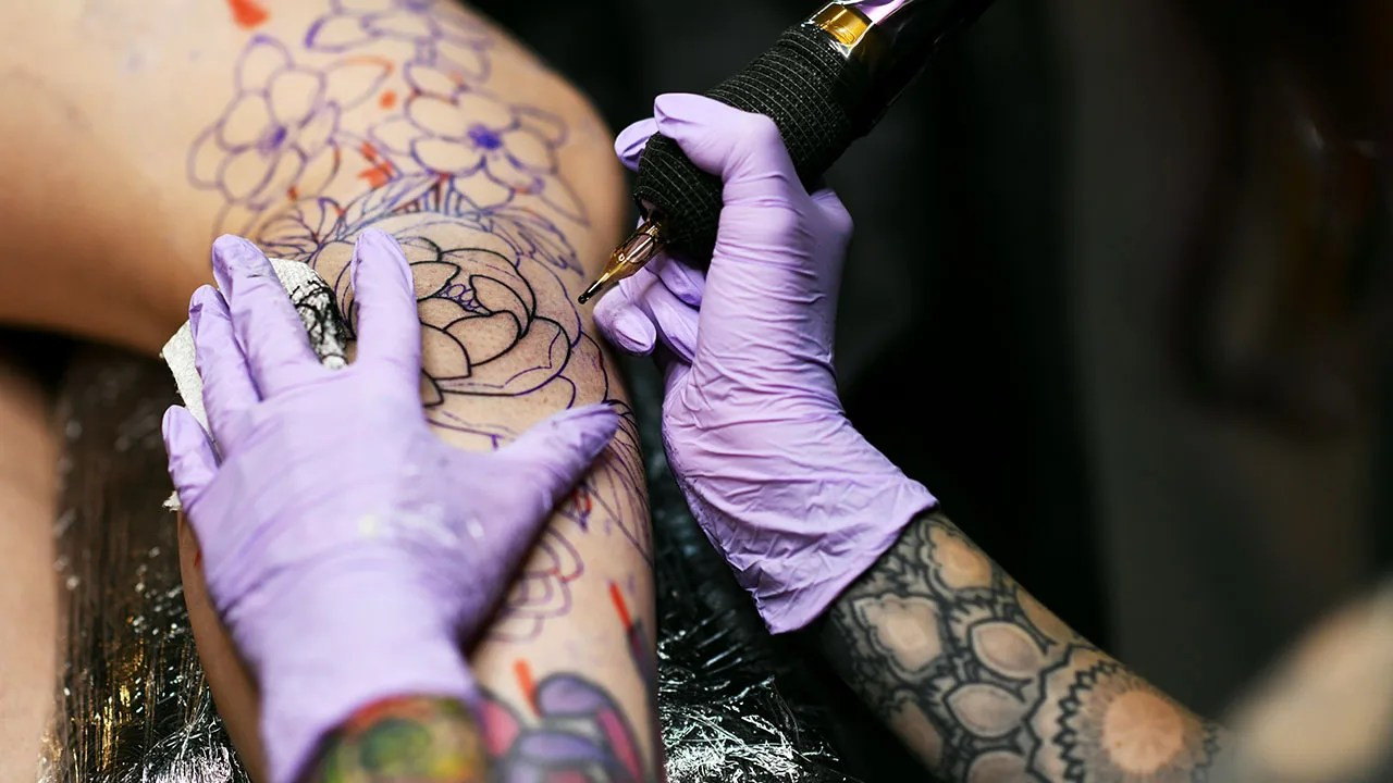 Close-up of a woman's arm with colorful tattoos