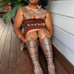 Tribal leg tattoo showcasing bold black ink geometric patterns
