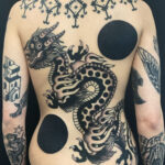 Close-up of an arm tattoo with a minimalist black design