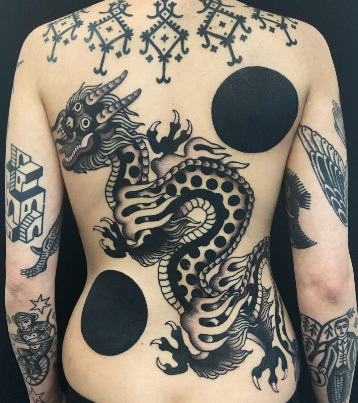 Close-up of an arm tattoo with a minimalist black design