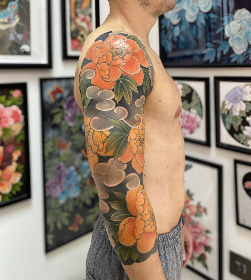 Beautiful watercolor peony tattoo by Rodrigo Souto with soft pinks and purples