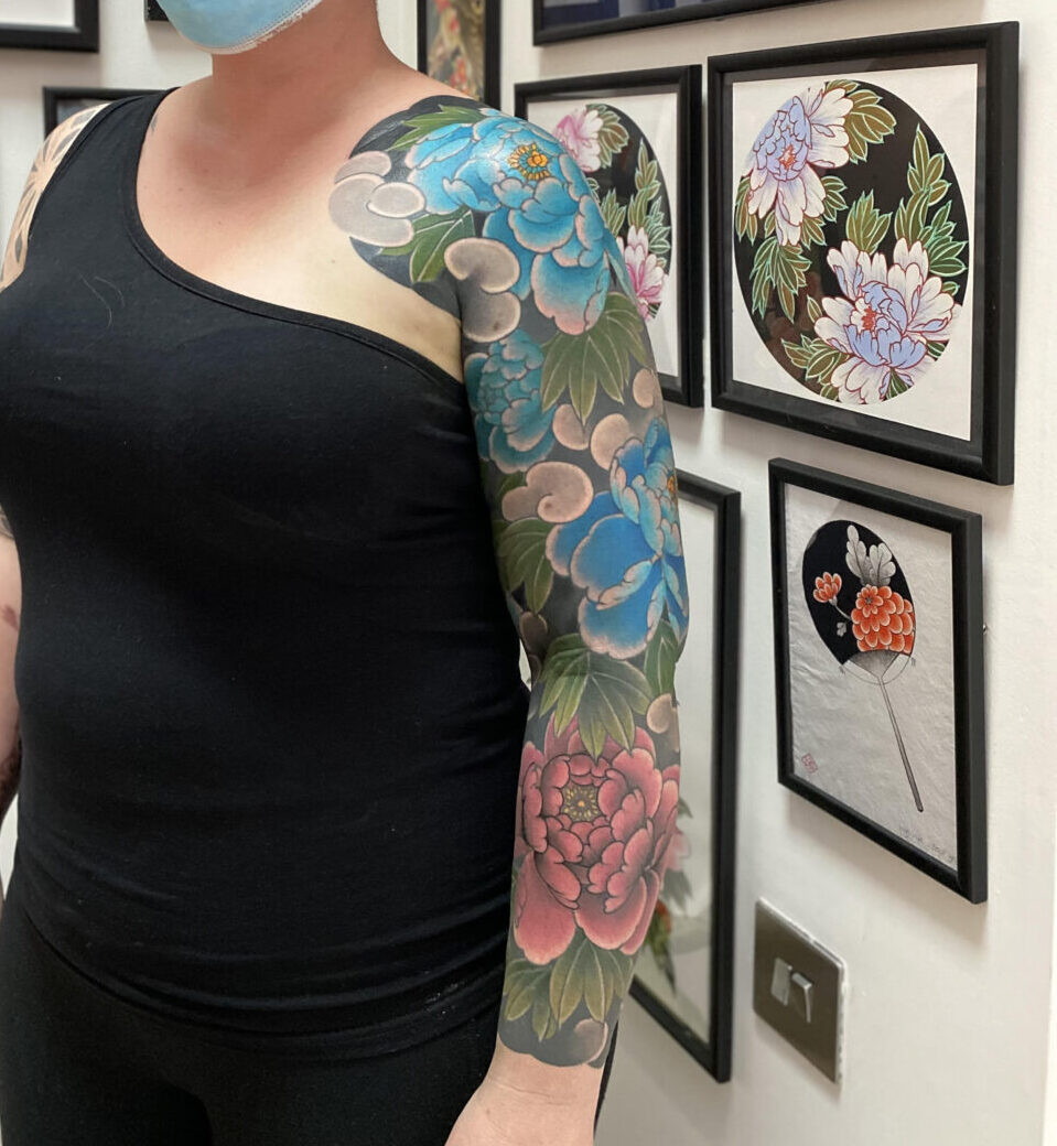 Watercolor peony tattoo by Rodrigo Souto with soft blended colors and fine lines