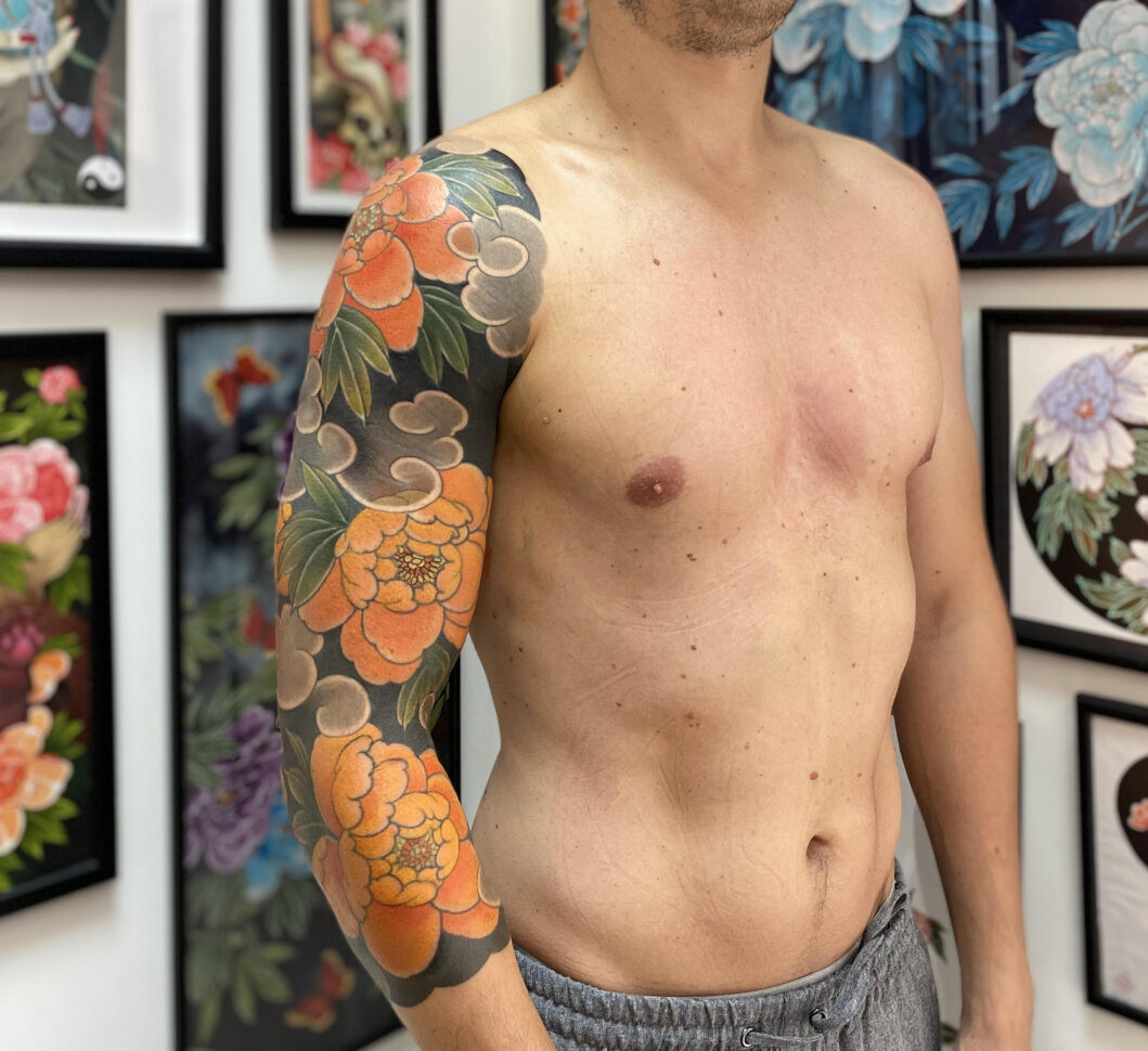 Peony thigh tattoo design by Rodrigo Souto with thick outlines and pink colors