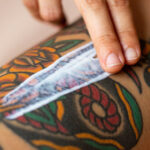 Fresh colorful tattoo on a woman's arm