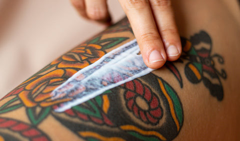 Fresh colorful tattoo on a woman's arm