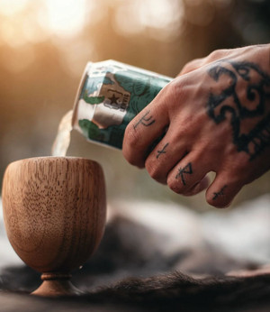 Tattooed Hand Pouring a Beer