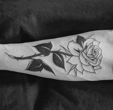 Rose tattoo with a banner design featuring personalized lettering