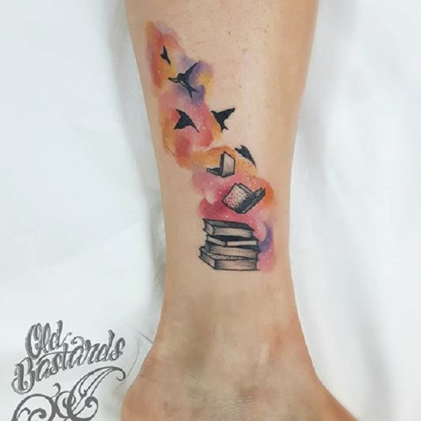 Tattoos of books with birds flying out