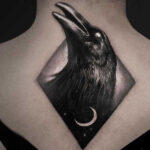 A crow tattoo design with intricate linework and feather details