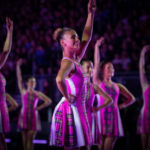 Highland dancers in vibrant costumes performing at The Royal Edinburgh Military Tattoo, showcasing traditional Scottish dance