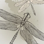 Intricate dragonfly tattoo on the upper back