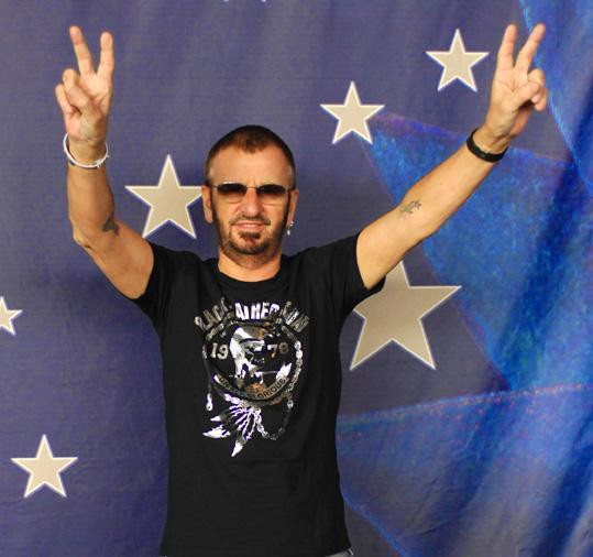 Close-up of Ringo Starr's right arm tattoo, showcasing a cross and lotus flower, representing peace, harmony, and spiritual growth