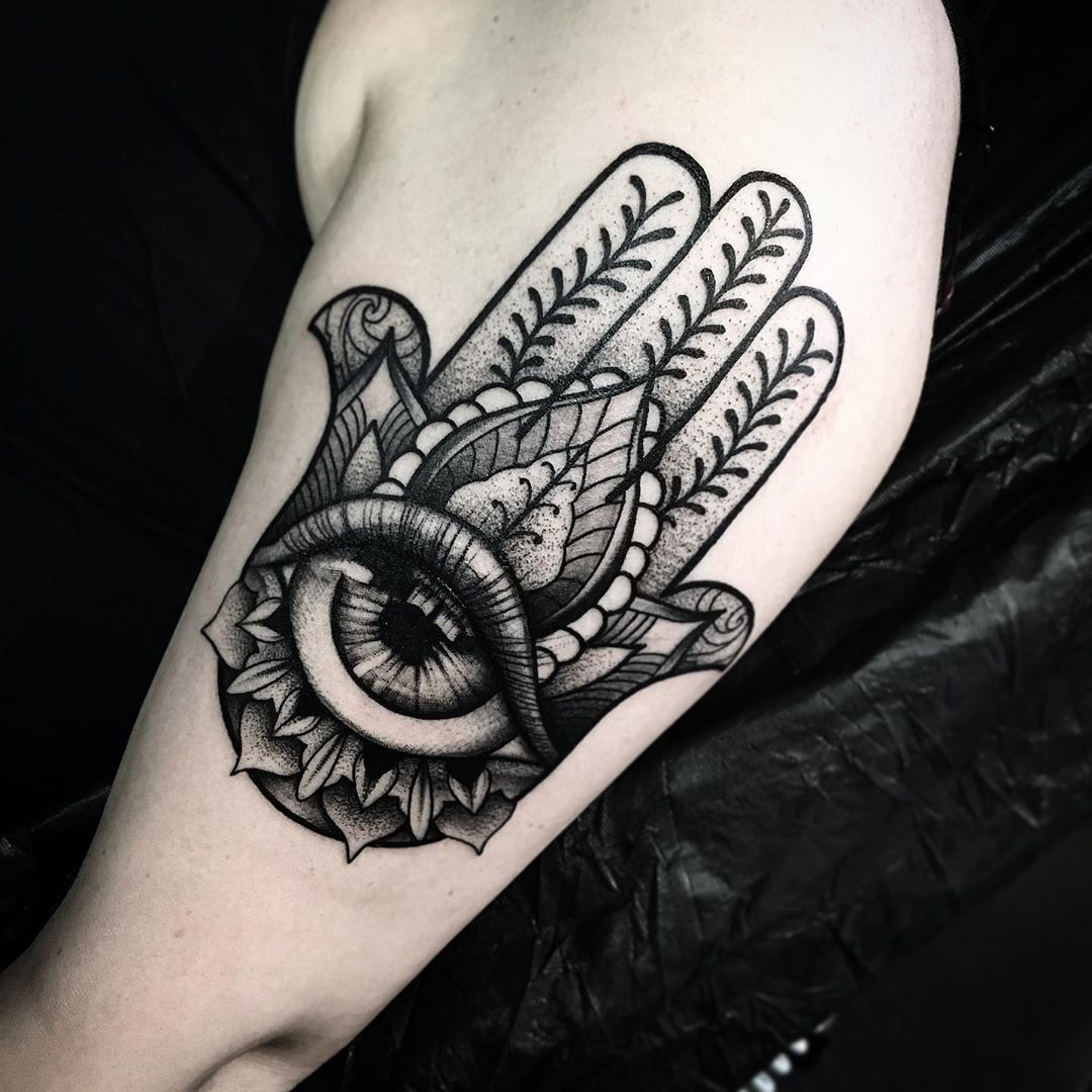 An intricately detailed Hamsa tattoo with geometric patterns and vibrant colors, blending modern art with ancient symbolism