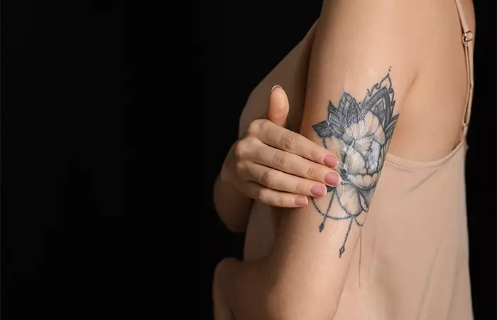 Applying aloe vera gently on tattoo