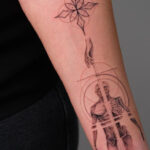 Large fine line tattoo on a person's arm, demonstrating intricate detailing and design