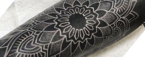 White ink tattoo on arm