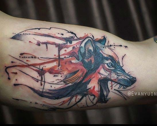 wolf face inner bicep tattoo for men symbolizing strength