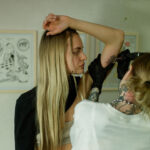 Woman wearing a loose button-up shirt, ideal for shoulder tattoo access.