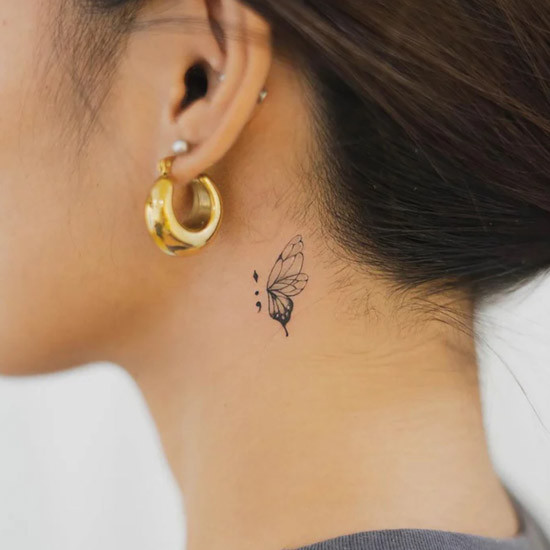 Woman neck tattoo of butterfly wings
