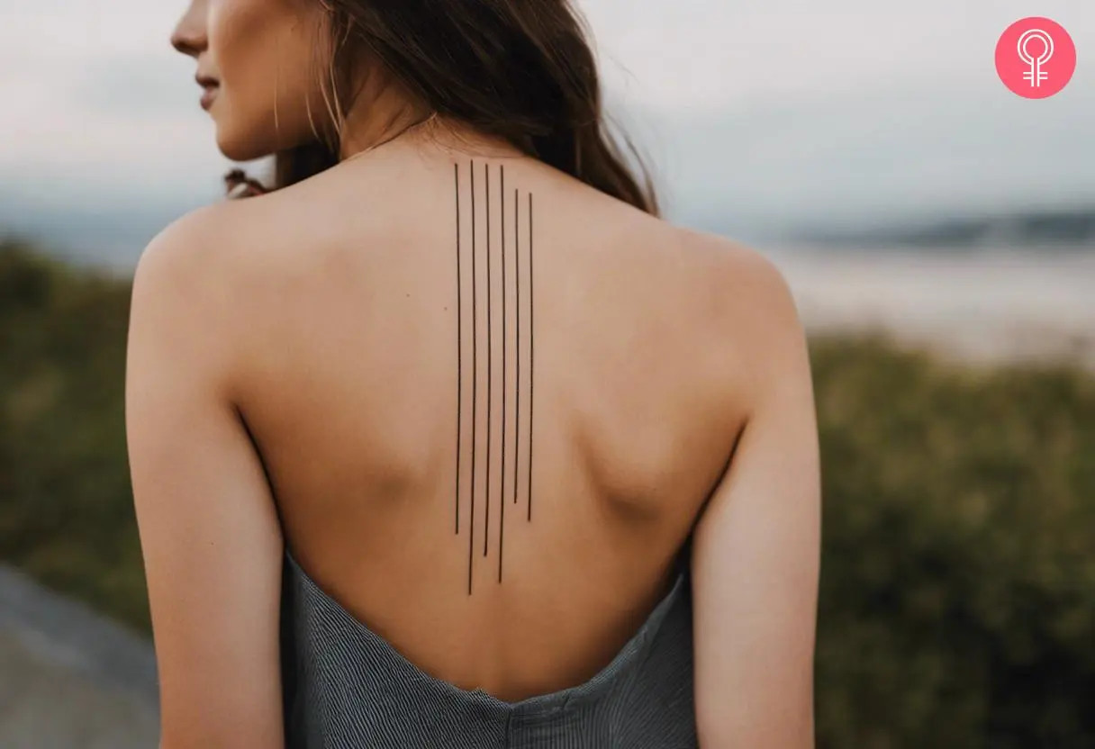 Woman with a straight line tattoo design on the back