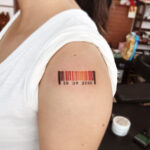 Barcode tattoo featuring personalized numbers and a heart symbol, representing a special date or anniversary.