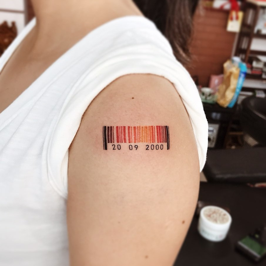 Barcode tattoo featuring personalized numbers and a heart symbol, representing a special date or anniversary.