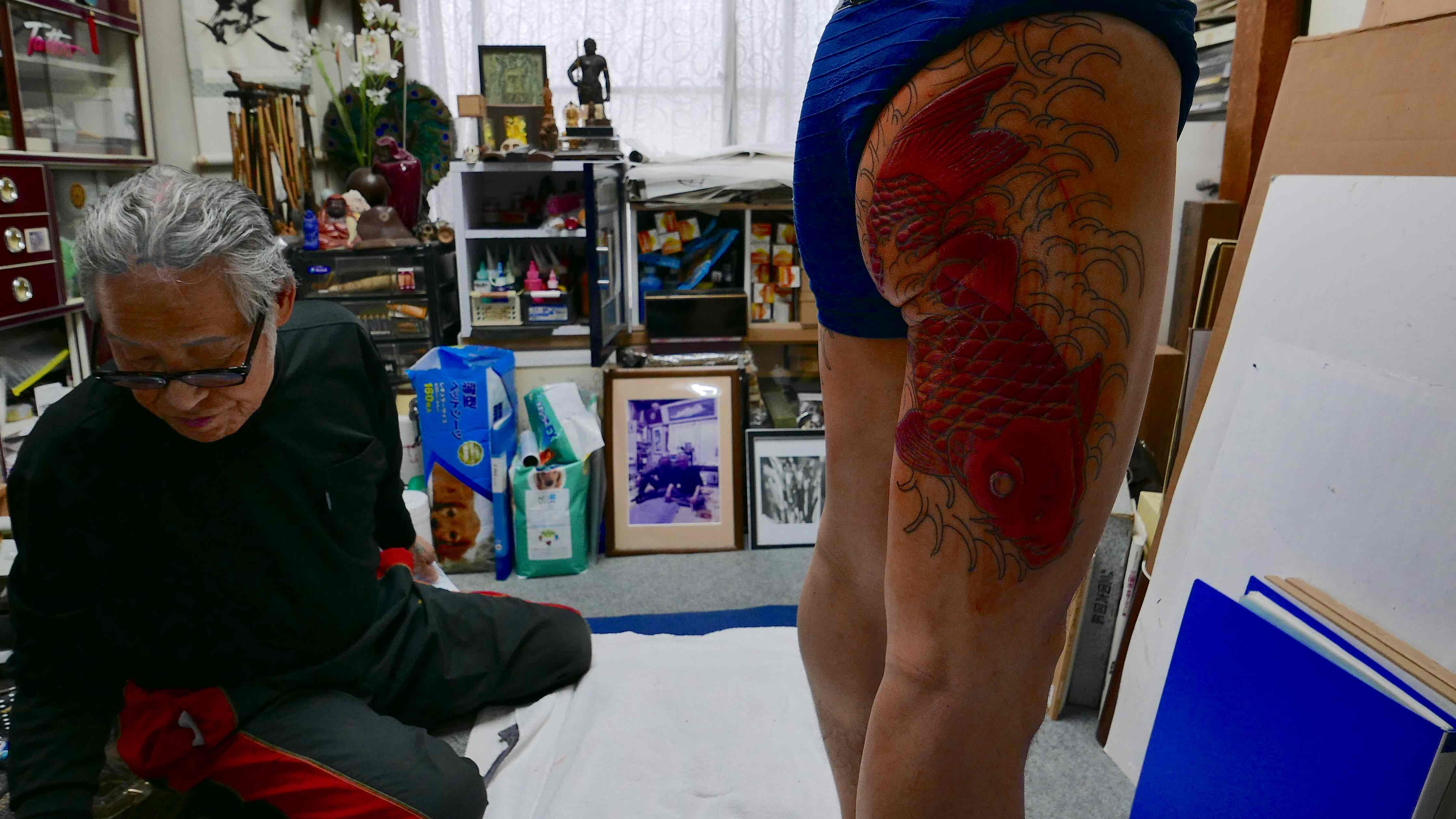 Yakuza elder with a koi fish tattoo representing perseverance and courage