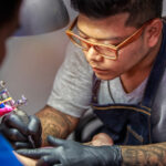 How Much Do Spine Tattoos Cost - A close-up of a well-healed spine tattoo featuring a delicate floral design, showcasing the importance of proper aftercare.