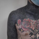 White ink over blackwork tattoo showcases intricate details and design.