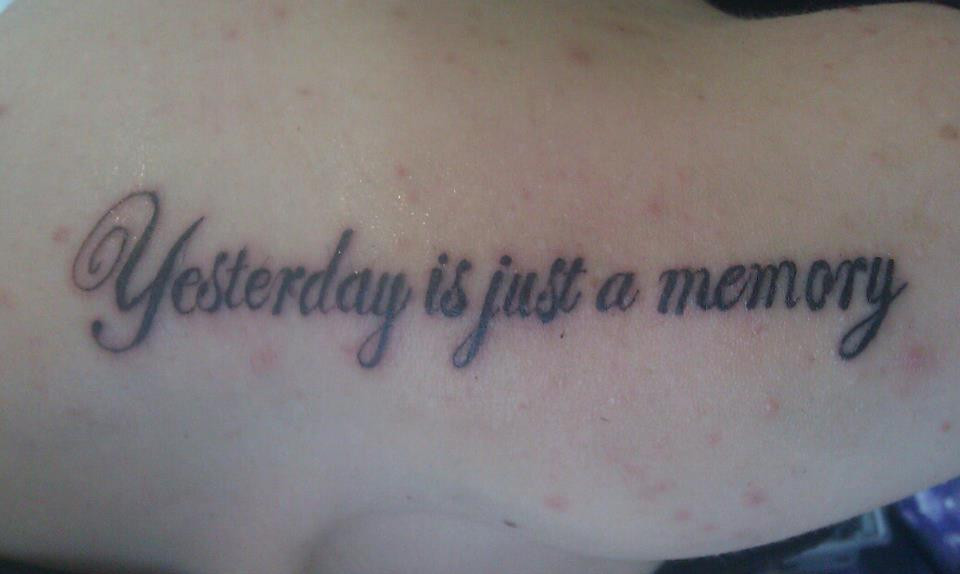 Alt text: A skilled tattoo artist meticulously working on a 'me myself and i' tattoo in a professional studio.
