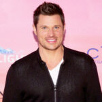 Nick Lachey's sun tattoo with '98 Degrees' inscription, symbolizing his boy band era pride.