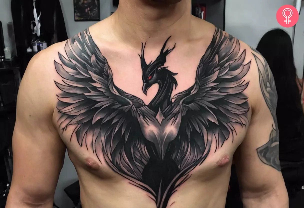 A man proudly displaying a Maleficent phoenix tattoo on his chest, an emblem of transformation and compassion