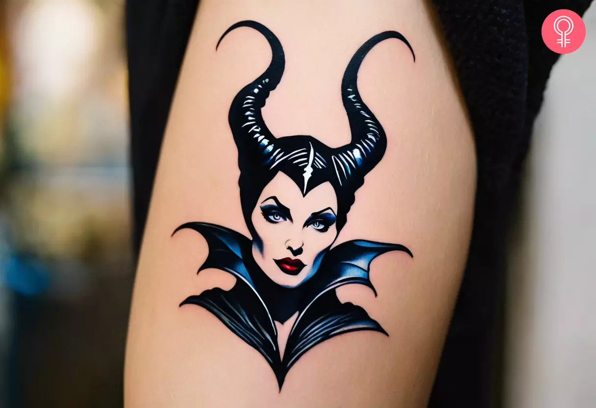 A woman sporting a small Maleficent tattoo on her upper arm, a mystical emblem of feminine power