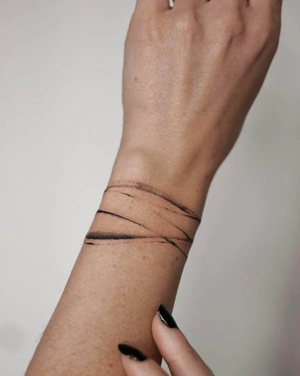 Simple abstract lines bracelet tattoo for women design by @olyabartno