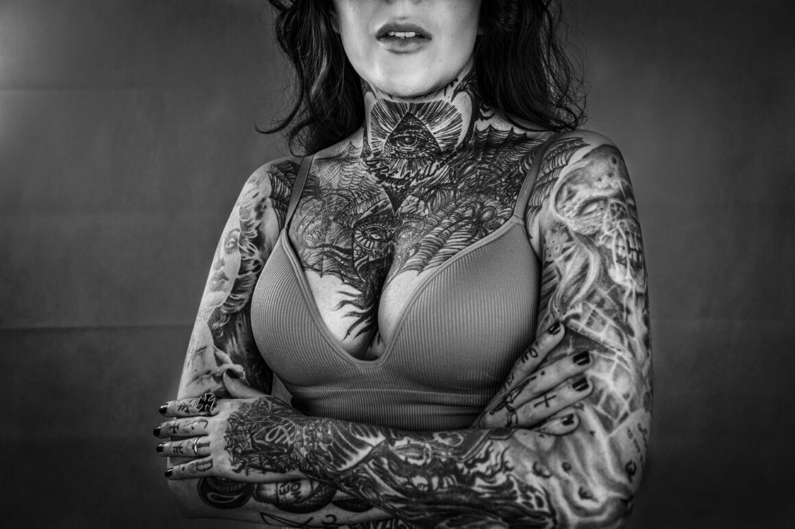 Singer Acid's Tattoo by Robert Hellstrom, showcasing a black and white portrait that captures the raw emotion and deep connection she has with her body art.