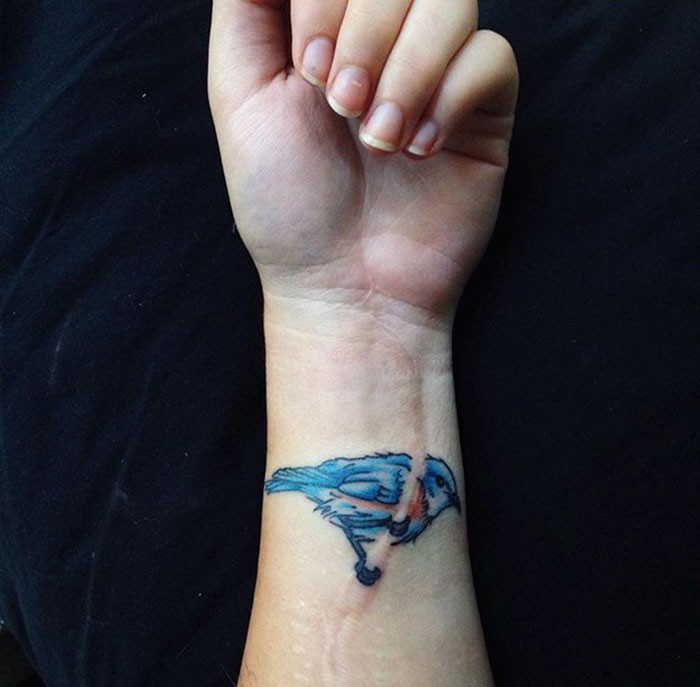 Scar cover up tattoo bird