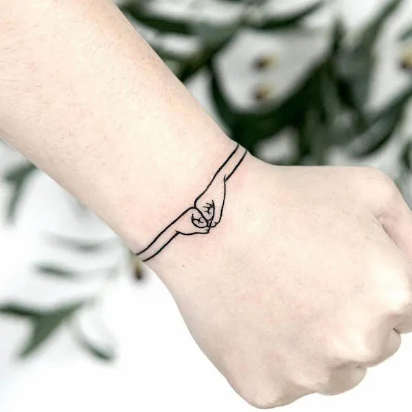 Creative bro fist bracelet tattoo design by @lana_here_tattoo
