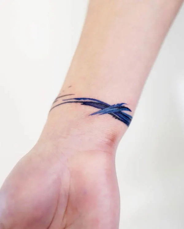 Artistic brushstroke bracelet tattoo for women by @9room_tattoo