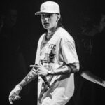 Peso Pluma's first tattoo, the letter 'P' on his forearm, representing the Peso Pluma project and his team